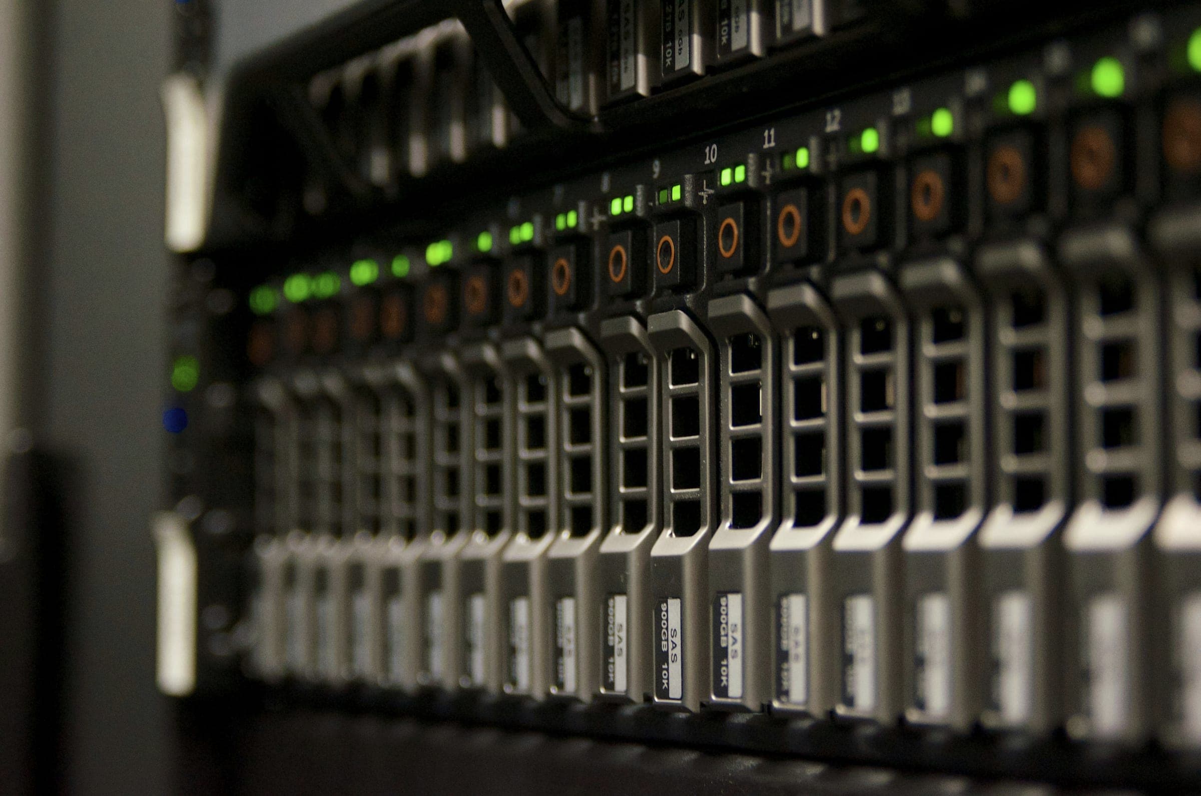 Rows of hot-swap drive bays with green status lights on a rack-mounted server.
